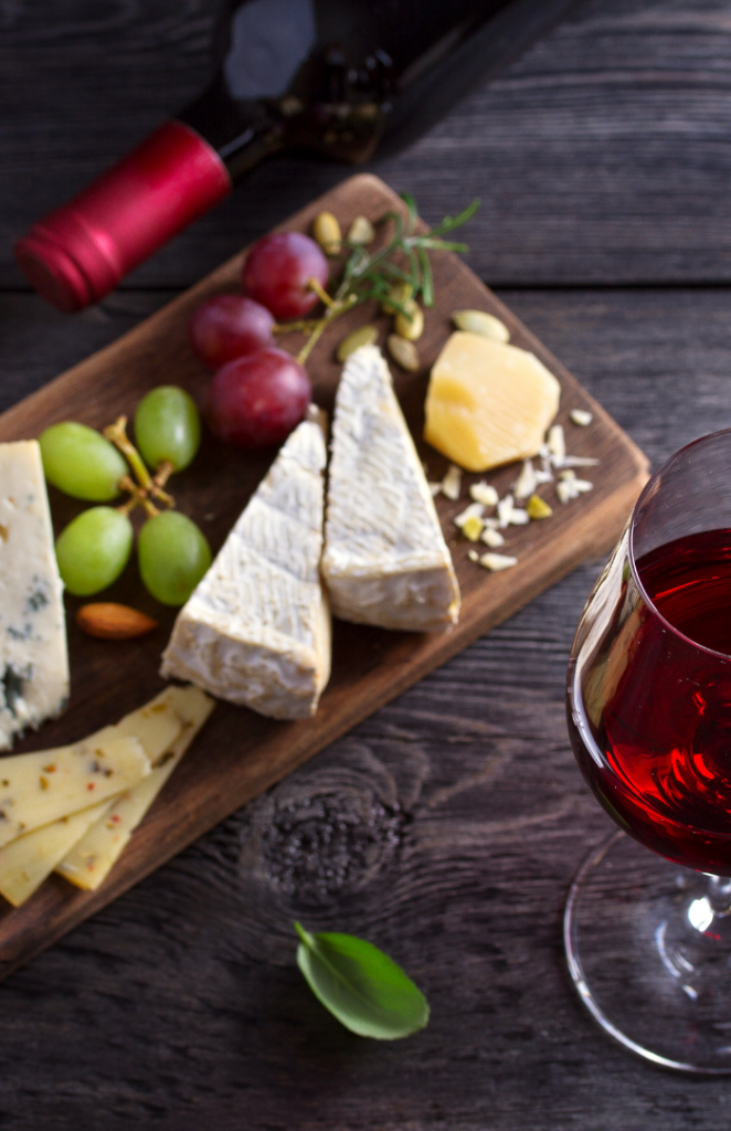 image of cheese plate with grapes and wine
